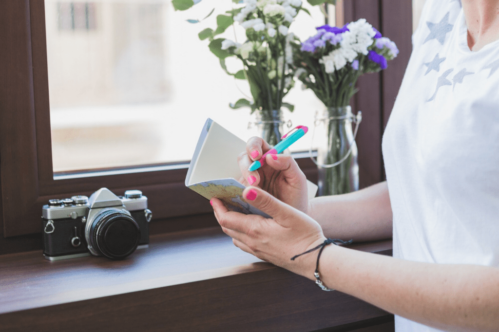 Close-up of hand holding an open notebook