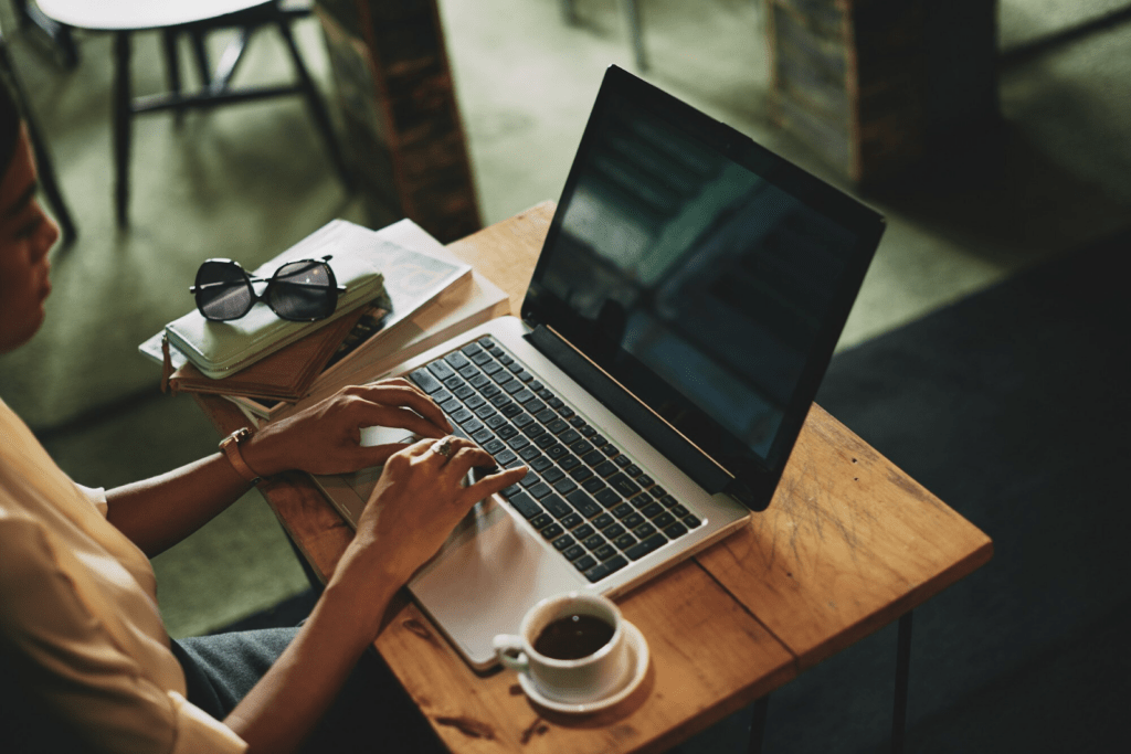 Woman sitting in cafe and working on laptop