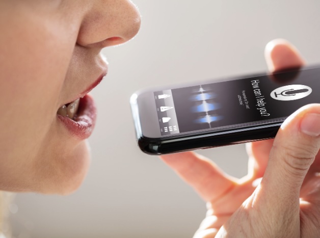 Woman using voice recognition on phone